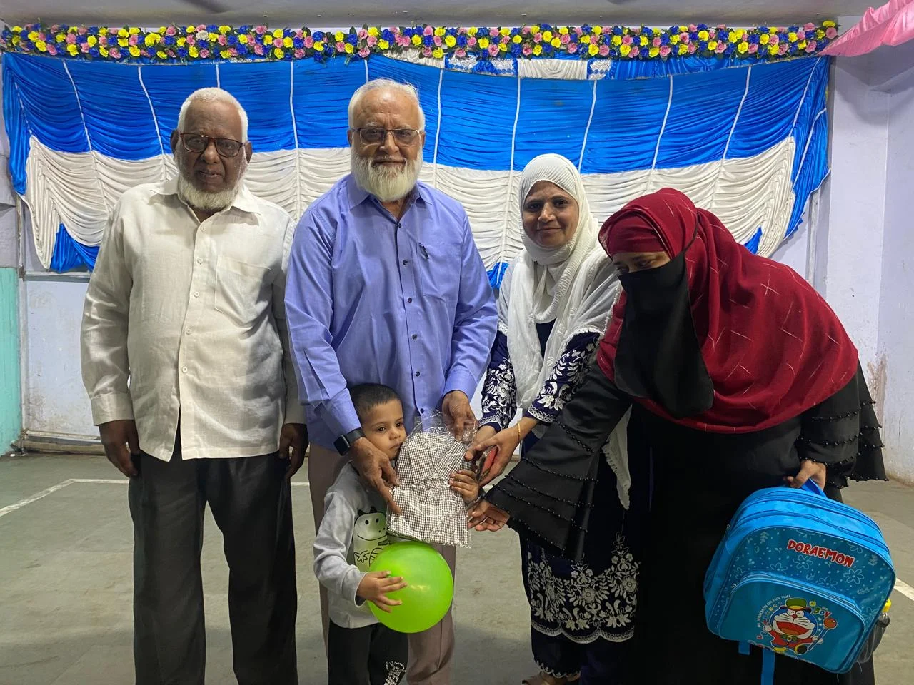 Society Leaders Handing Over Kits to Young Student